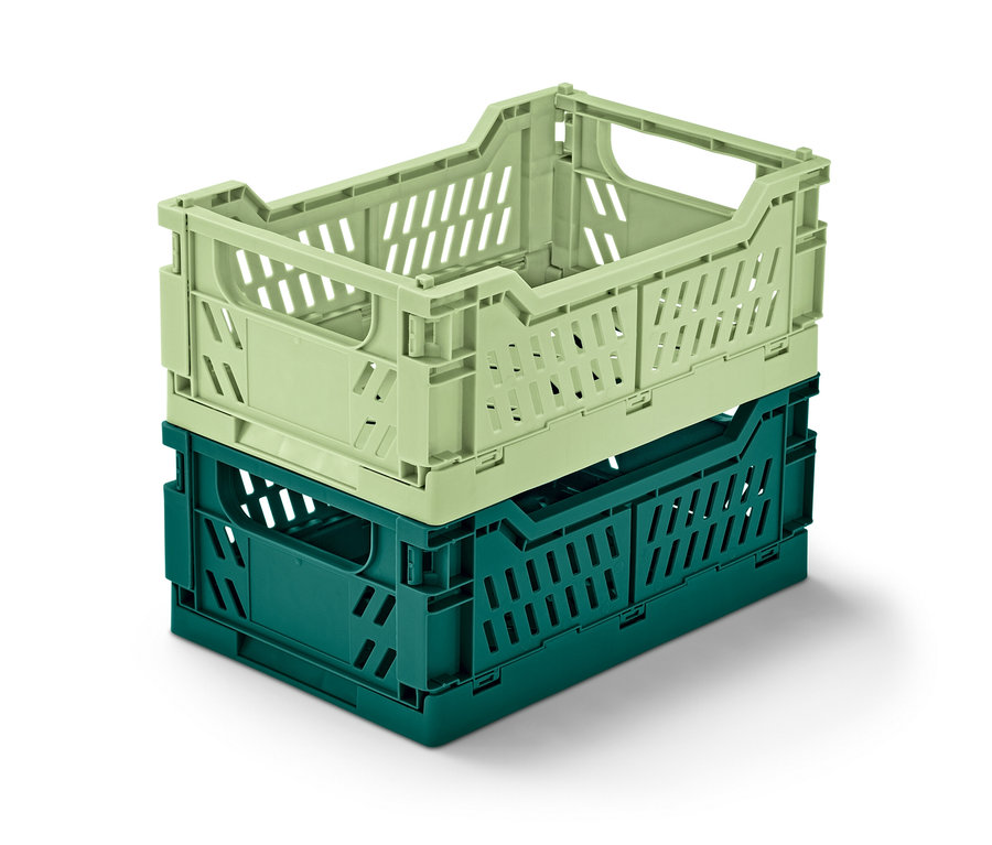 Dva skládací úložné boxy naskládané na sobě. Horní box je světle zelený a spodní box je tmavě zelený.