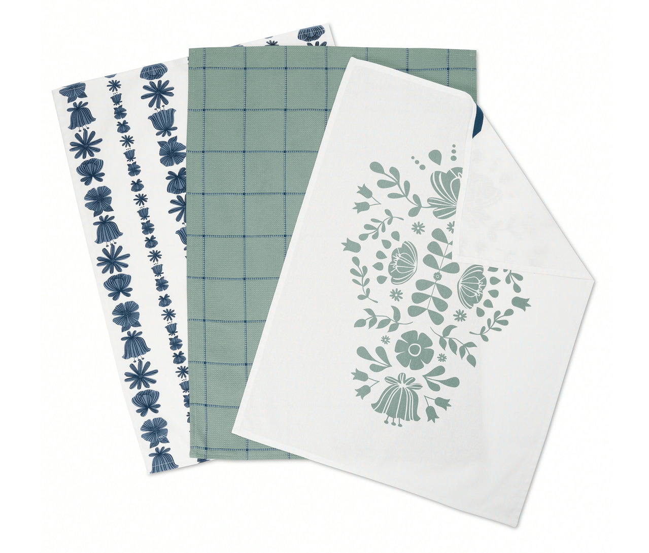 Tři složené utěrky: jedna s modrými květy, jedna se zelenou mřížkou a jedna s květinovým vzorem.