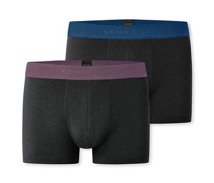 Dvoje černé dlouhé boxerky SCHIESSER leží na sobě.