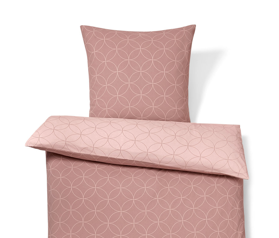 Růžové povlečení ze zimního žerzeje s kruhovým vzorem.