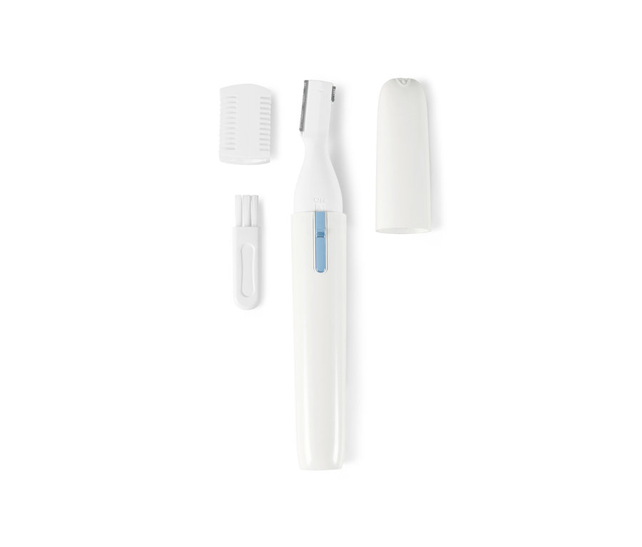 Bílý elektrický kosmetický holicí strojek s nástavci a kartáčkem na čištění.