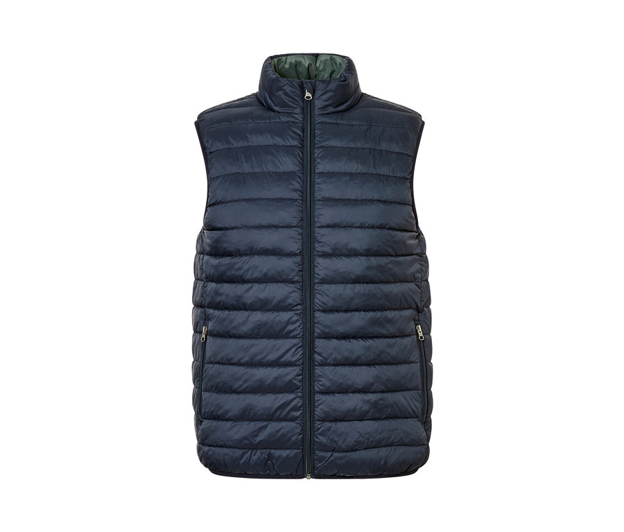 Tmavě modrá oboustranná vesta se zipem uprostřed.