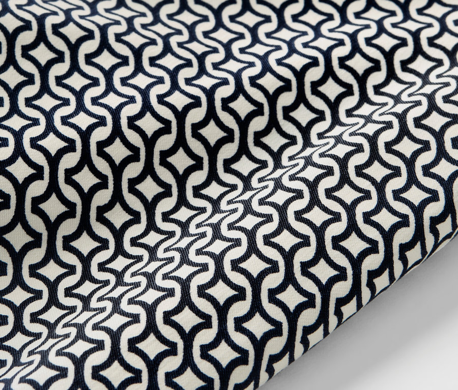 Detailní záběr na námořnicky modré strečové kalhoty s potiskem.