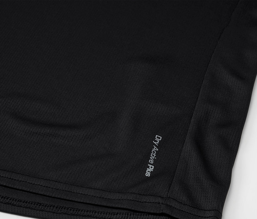 Detailní záběr na černou sportovní košili s nápisem "Dry Active Plus" v dolní části.