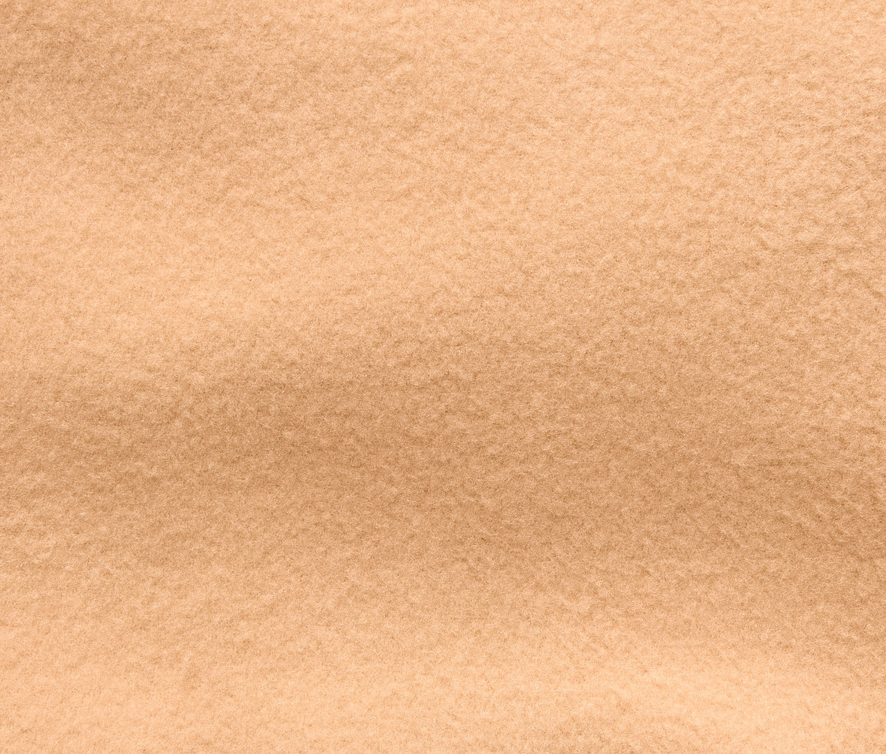 Detailní záběr na texturu béžové látky.