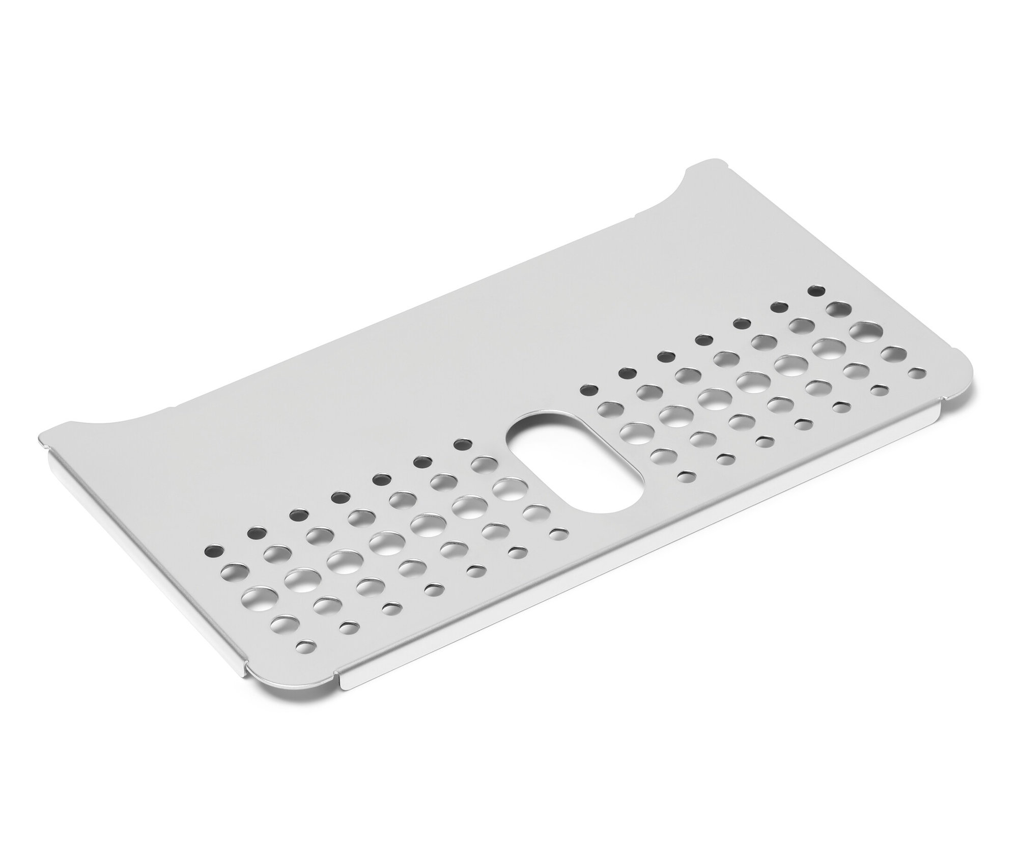 Detailní záběr odkapávací mřížky pro plnoautomatické kávovary Tchibo na bílém pozadí.