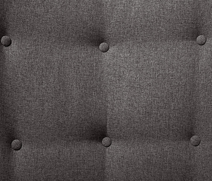 Detail látky tmavě šedého křesla s podnožkou a knoflíky.