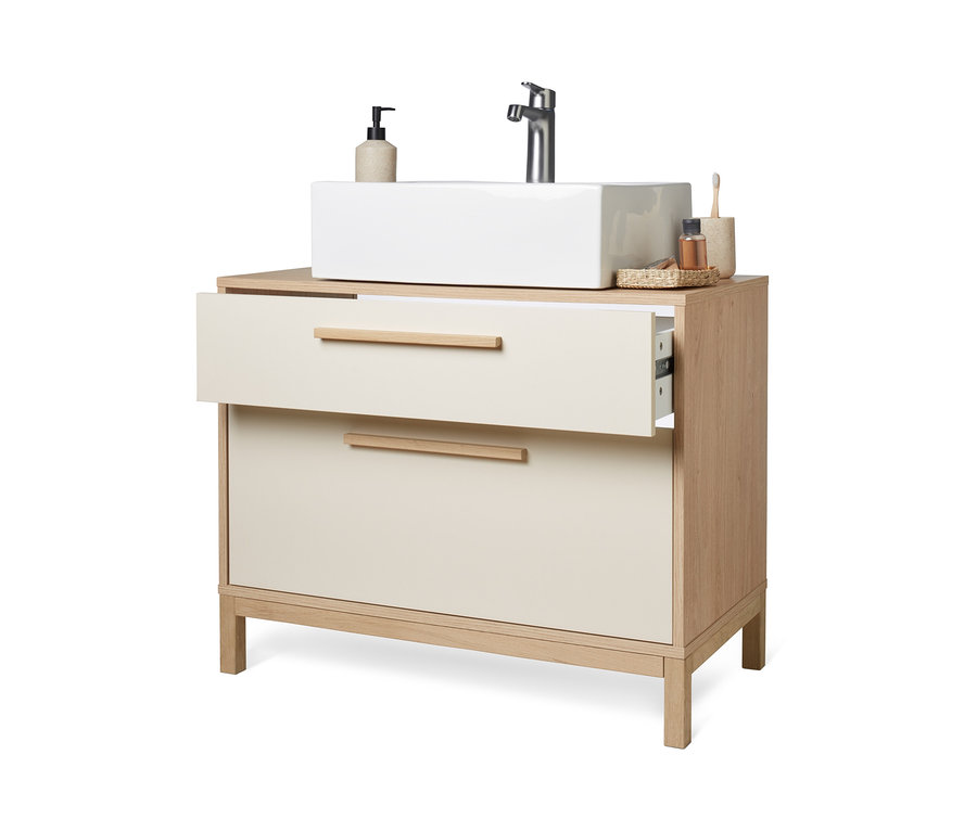 Koupelnová skříňka pod umyvadlo Eklund vanilkové barvy s otevřenou horní zásuvkou.