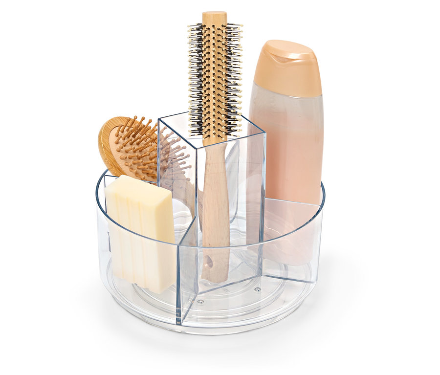 Čirá otočná nádoba s mýdlem, kartáčem na vlasy a lahví šamponu.