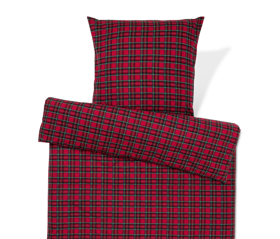 Červené kostkované povlečení s polštářem.