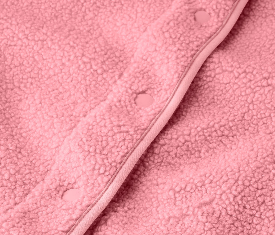 Detail růžové plyšové vesty se zapínáním na knoflíky.