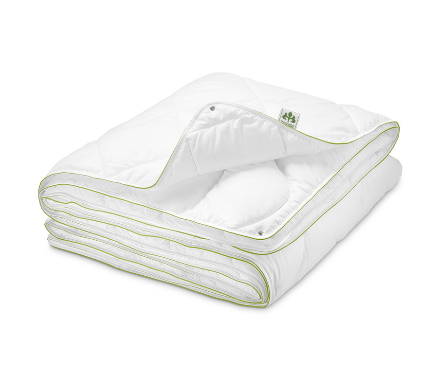 Složená bílá prošívaná přikrývka irisette® greenline s lemováním.