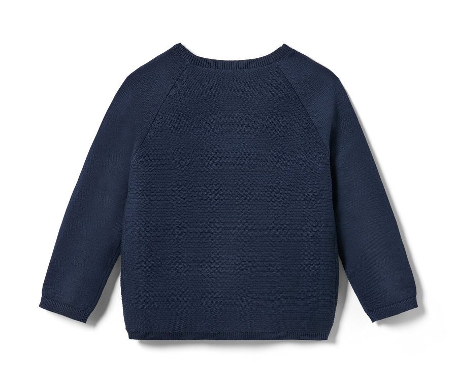 Detail dětského pleteného kabátku.