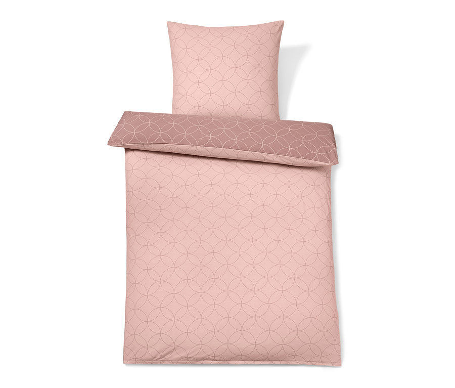 Růžové povlečení ze zimního žerzeje s kruhovým vzorem.