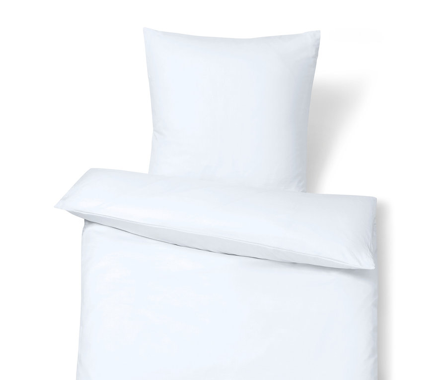 Detail bílého povlečení s polštářem nahoře.
