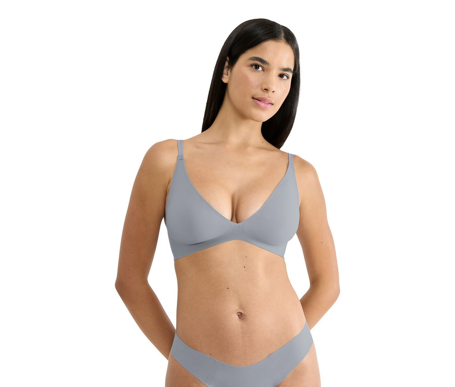 Žena má na sobě šedou podprsenku a spodní prádlo.