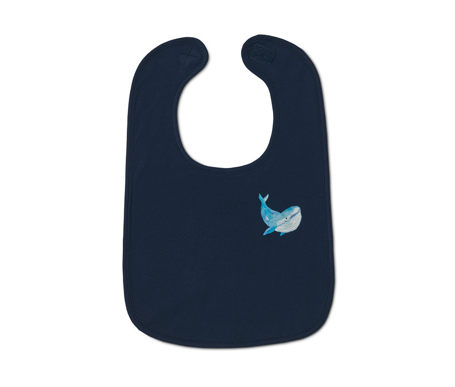 Tmavě modrý bryndáček s obrázkem modré velryby.