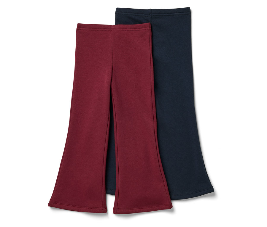 Dvoje kalhoty do zvonu: jedny vínové a jedny tmavě modré.