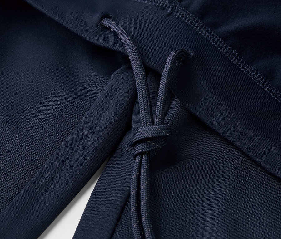 Detail modrých běžeckých legín Windprotection se stahovací šňůrkou.