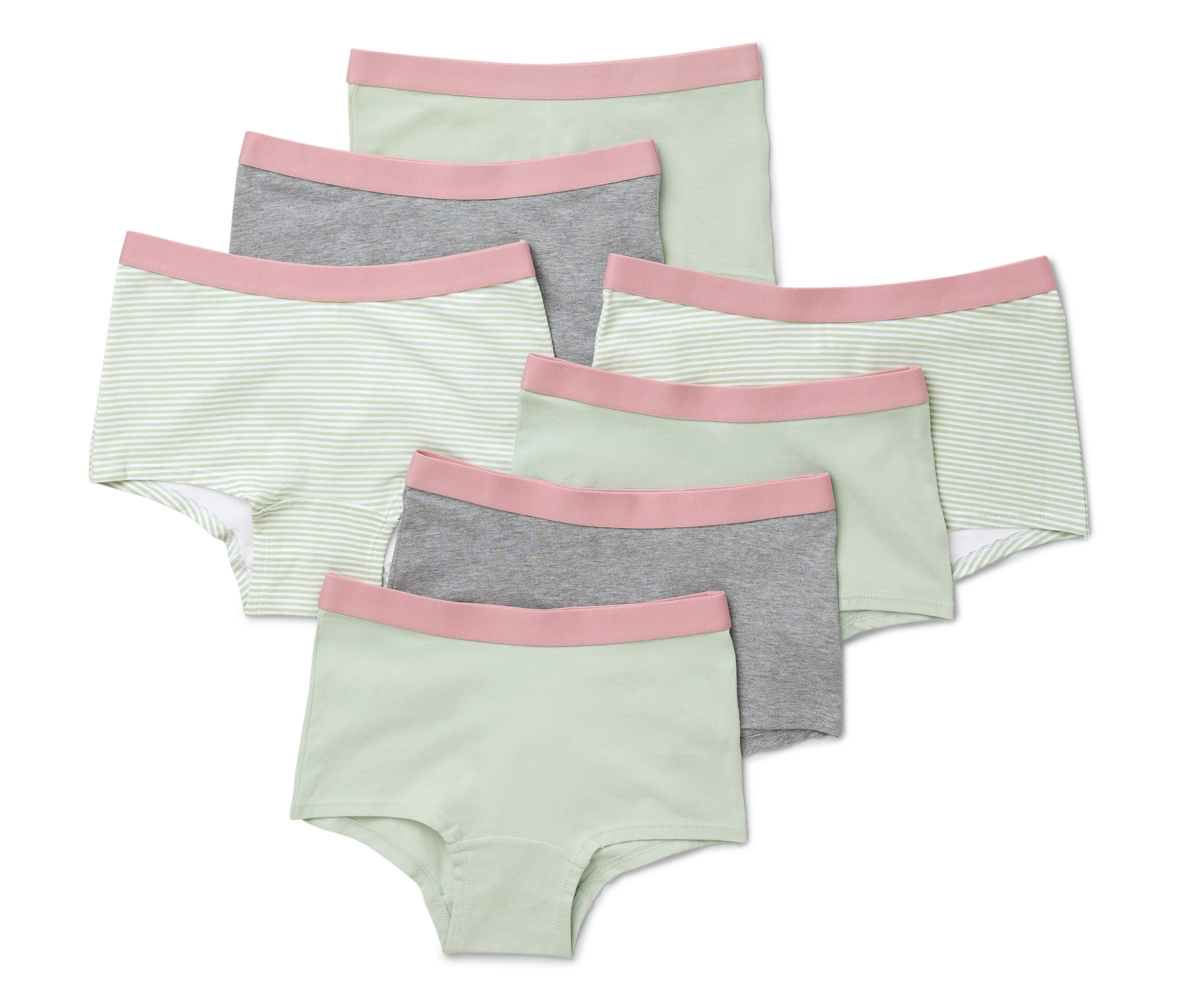 Sedm mátově zelených dívčích kalhotek leží na sobě.