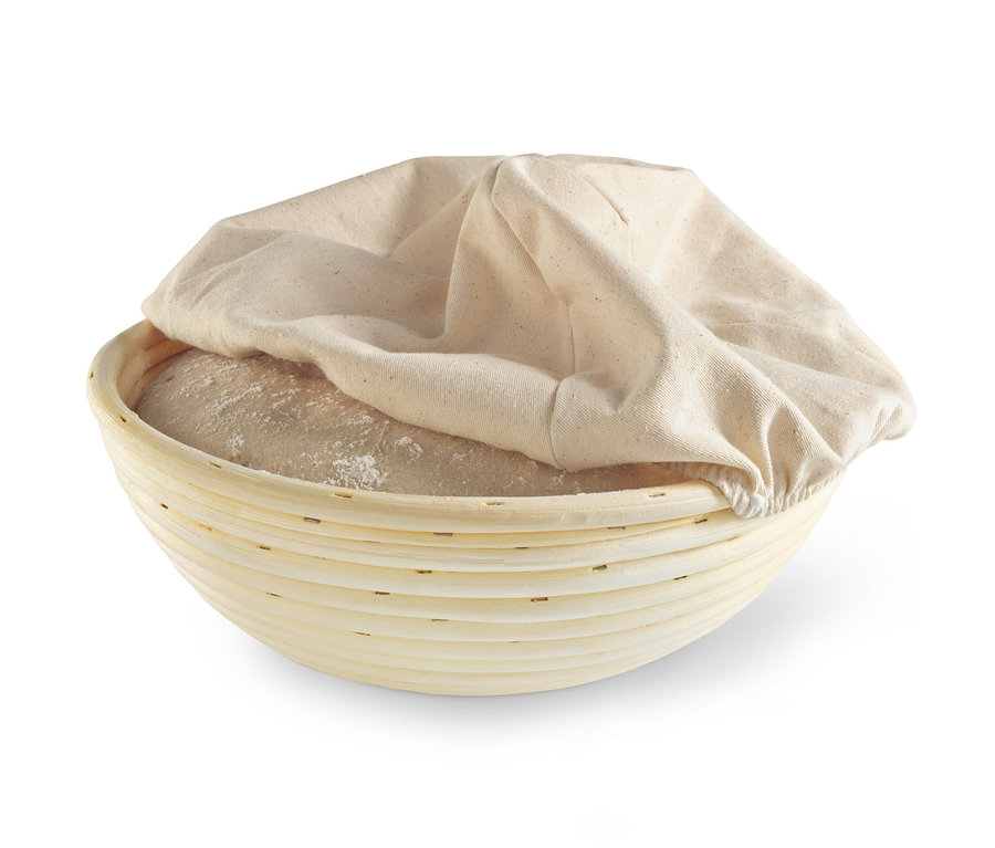 Kulatá ošatka na kynutí těsta s těstem a látkovým obalem.