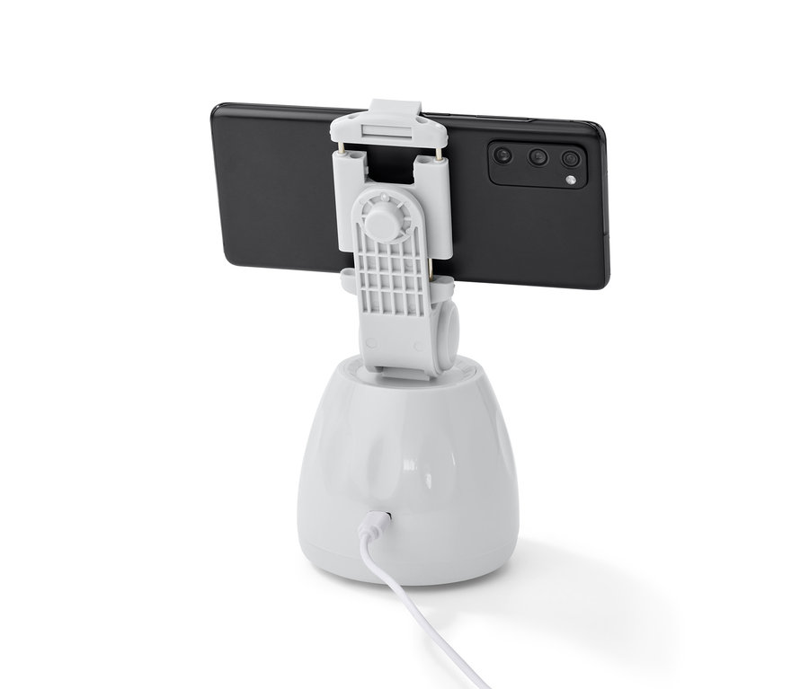 Černý mobilní telefon je připevněn k bílému držáku mobilního telefonu se senzorem pohybu.
