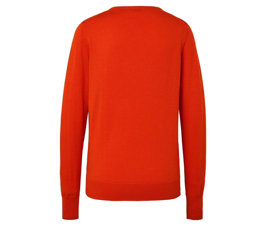 Detail zadní strany oranžového svetru s dlouhými rukávy.