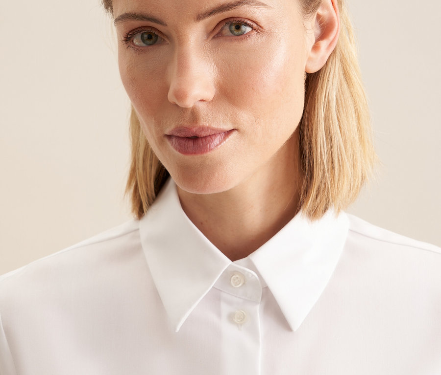 Portrét ženy v bílé nežehlivé halence Seidensticker.