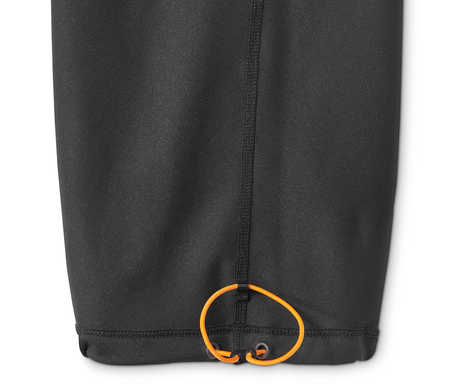 Detail černých sportovních kalhot se stahovací šňůrkou v lemu.
