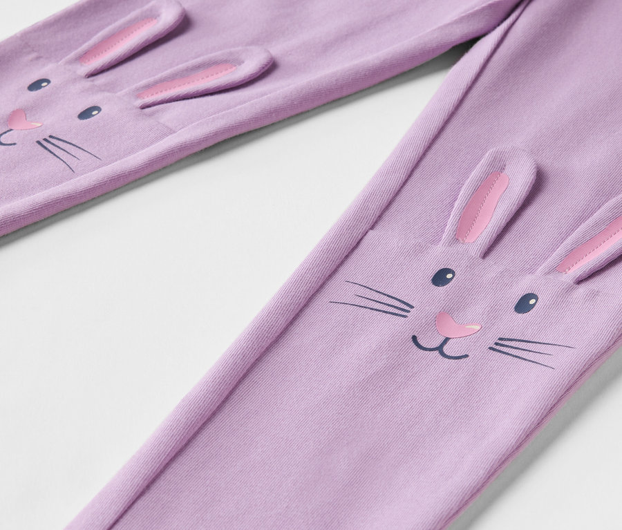 Detail fialových legín s obličejem králíka s 3D ušima.